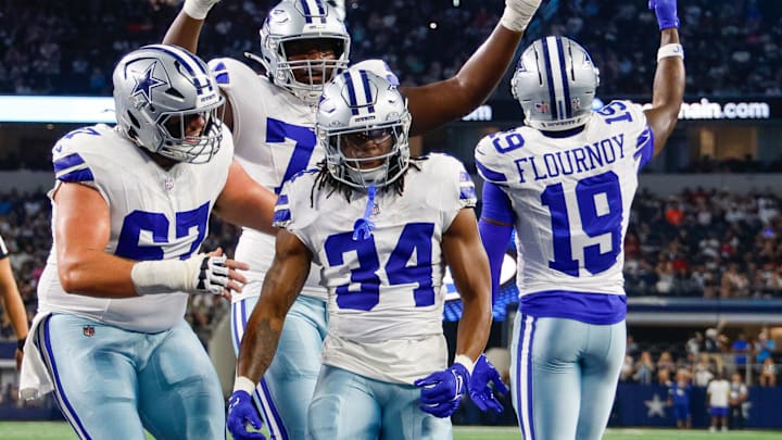 Teammates celebrate with Dallas Cowboys running back Jaydon Blue after he scores a touchdown against the Atlanta Falcons 