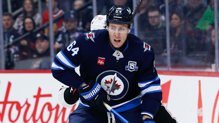 Mar 3, 2026; Winnipeg, Manitoba, CAN;  Winnipeg Jets defenseman Logan Stanley (64) skates away from Chicago Blackhawks defenseman Artyom Levshunov (55) during the first period at Canada Life Centre. Mandatory Credit: Terrence Lee-Imagn Images