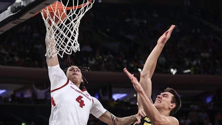 Arkansas Razorbacks forward Trevon Brazile (4) dunks past Michigan Wolverines center Vladislav Goldin (50) in the first half at Madison Square Garden. 