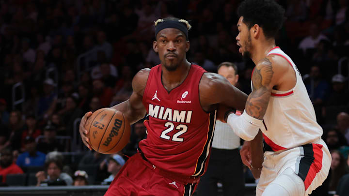 Jan 21, 2025; Miami, Florida, USA; Miami Heat forward Jimmy Butler (22) drives to the basket past Portland Trail Blazers guard Anfernee Simons (1) during the second quarter at Kaseya Center. Mandatory Credit: Sam Navarro-Imagn Images