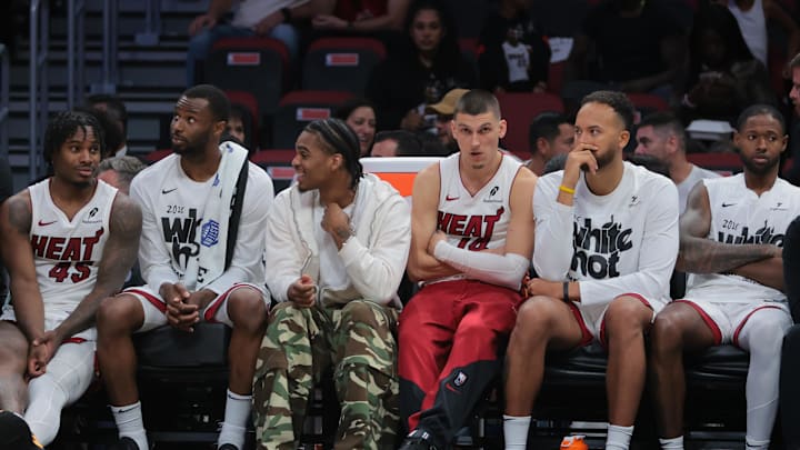 Apr 28, 2025; Miami, Florida, USA; Miami Heat guard Tyler Herro (center) looks on from the bench against the Cleveland Cavaliers in the fourth quarter during game four for the first round of the 2025 NBA Playoffs at Kaseya Center. Mandatory Credit: Sam Navarro-Imagn Images