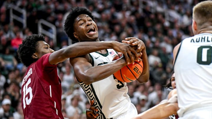 Michigan State's Cam Ward, right, is fouled by Colgate's Ayomi Odetoyinbo during the second half on Monday, Nov. 3, 2025, at the Breslin Center in East Lansing.