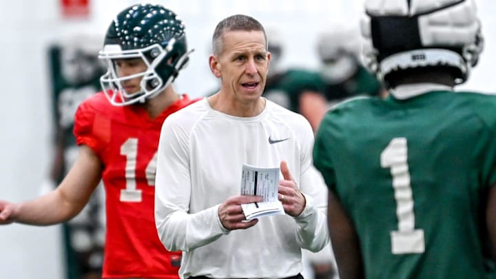 Michigan State's offensive coordinator Jay Johnson, left, talks with Jayden Reed during practice on Tuesday, March 29, 2022, at the indoor football facility in East Lansing. Michigan State's offensive coordinator Jay Johnson, left, talks with Jayden Reed during practice on Tuesday, March 29, 2022, at the indoor football facility in East Lansing.