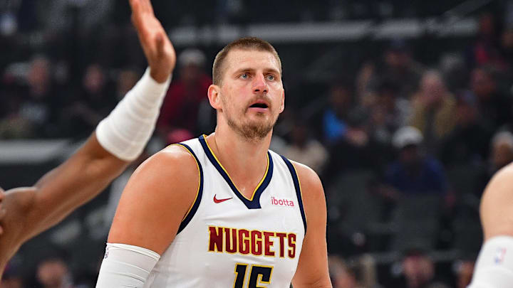 Apr 24, 2025; Inglewood, California, USA; Denver Nuggets center Nikola Jokic (15) controls the ball against Los Angeles Clippers center Ivica Zubac (40) and guard Kris Dunn (8) during the first half of game three in the first round for the 2024 NBA Playoffs at Intuit Dome. Mandatory Credit: Gary A. Vasquez-Imagn Images