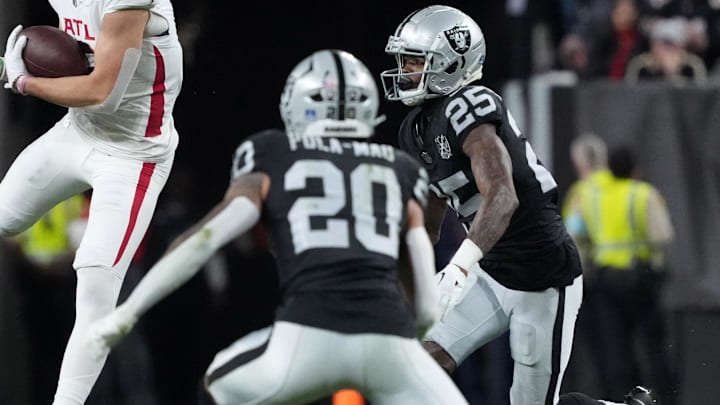 Dec 16, 2024; Paradise, Nevada, USA; Atlanta Falcons wide receiver Drake London (5) catches the ball against Las Vegas Raiders safety Isaiah Pola-Mao (20) and cornerback Decamerion Richardson (25) in the first half at Allegiant Stadium. Mandatory Credit: Kirby Lee-Imagn Images Dec 16, 2024; Paradise, Nevada, USA; Atlanta Falcons wide receiver Drake London (5) catches the ball against Las Vegas Raiders safety Isaiah Pola-Mao (20) and cornerback Decamerion Richardson (25) in the first half at Allegiant Stadium. Mandatory Credit: Kirby Lee-Imagn Images