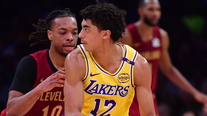 Dec 31, 2024; Los Angeles, California, USA; Los Angeles Lakers guard Max Christie (12) controls the ball against Cleveland Cavaliers guard Darius Garland (10) during the second half at Crypto.com Arena. Mandatory Credit: Gary A. Vasquez-Imagn Images