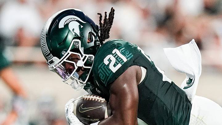 Michigan State running back Marvis Parrish (21) runs against Toledo safety Armorion Smith (7) during the first half at Spartan Stadium in East Lansing on Friday, Sept. 4, 2026. Michigan State running back Marvis Parrish (21) runs against Toledo safety Armorion Smith (7) during the first half at Spartan Stadium in East Lansing on Friday, Sept. 4, 2026.