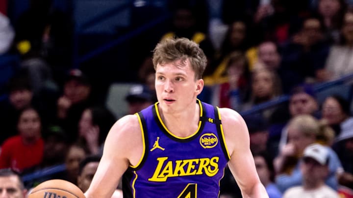 Nov 16, 2024; New Orleans, Louisiana, USA; Los Angeles Lakers guard Dalton Knecht (4) brings the ball up court against the New Orleans Pelicans during the first half at Smoothie King Center. Mandatory Credit: Stephen Lew-Imagn Images