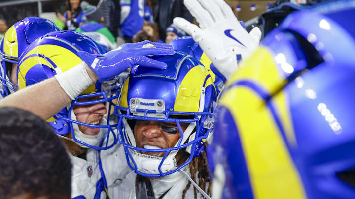 Nov 3, 2024; Seattle, Washington, USA; Los Angeles Rams wide receiver Demarcus Robinson (15, middle-right) celebrates with teammates, including wide receiver Cooper Kupp (10, left), after catching a game-wining touchdown pass against the Seattle Seahawks during overtime at Lumen Field. Mandatory Credit: Joe Nicholson-Imagn Images