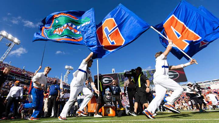 Florida Gators head coach Billy Napier runs out of the tunnel at the start of the Florida Georgia