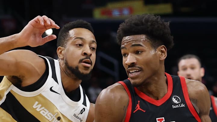 Toronto Raptors guard Ochai Agbaji drives to the basket as Washington Wizards guard CJ McCollum defends.