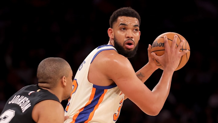 Mar 1, 2026; New York, New York, USA; New York Knicks center Karl-Anthony Towns (32) controls the ball against San Antonio Spurs forward Keldon Johnson (3) during the second quarter at Madison Square Garden.