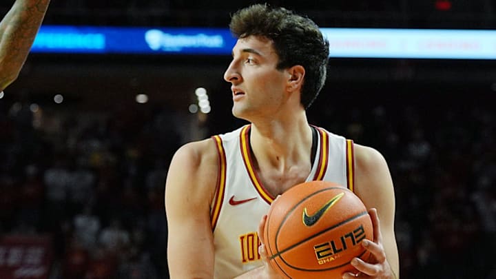 Iowa State Cyclones forward Milan Momcilovic (22) looks for pass around UCF Knights guard Kris Parker (5) during the first half in the Big-12 conference men’s basketball on Jan. 20, 2026, at Hilton Coliseum in Ames, Iowa.