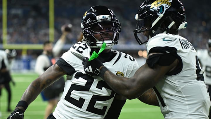 Dec 28, 2025; Indianapolis, Indiana, USA; Jacksonville Jaguars cornerback Jarrian Jones (22) celebrates with defensive end Josh Hines-Allen (41) after an interception during the second half against the Indianapolis Colts at Lucas Oil Stadium. Mandatory Credit: Robert Goddin-Imagn Images