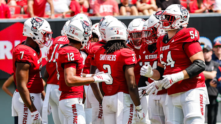 Sep 6, 2025; Raleigh, North Carolina, USA; North Carolina State Wolfpack huddle during the first half of the game against Virginia Cavaliers at Carter-Finley Stadium. Mandatory Credit: Jaylynn Nash-Imagn Images Sep 6, 2025; Raleigh, North Carolina, USA; North Carolina State Wolfpack huddle during the first half of the game against Virginia Cavaliers at Carter-Finley Stadium. Mandatory Credit: Jaylynn Nash-Imagn Images
