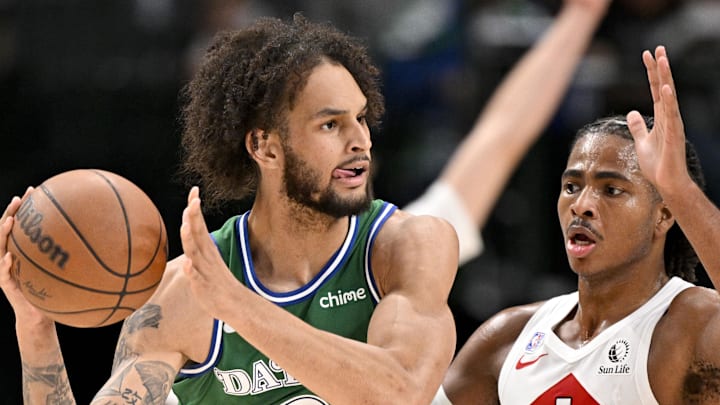Dallas Mavericks center Dereck Lively II looks to move the ball past Toronto Raptors forward Collin Murray-Boyles.