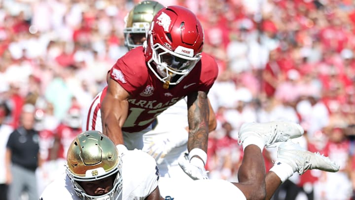 Notre Dame Fighting Irish running back Jadarian Price (24) dives toward the end zone during the first quarter as Arkansas Razorbacks defensive back Kani Walker (13) defends at Razorback Stadium. Notre Dame Fighting Irish running back Jadarian Price (24) dives toward the end zone during the first quarter as Arkansas Razorbacks defensive back Kani Walker (13) defends at Razorback Stadium.