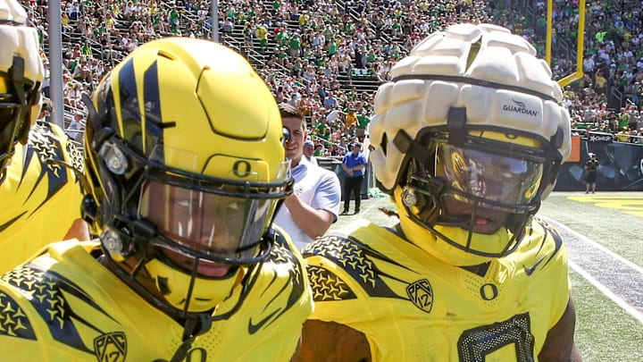 Bucky Irving celebrates a touchdown by wide receiver Tez Johnson as the Oregon Ducks host their annual spring game.