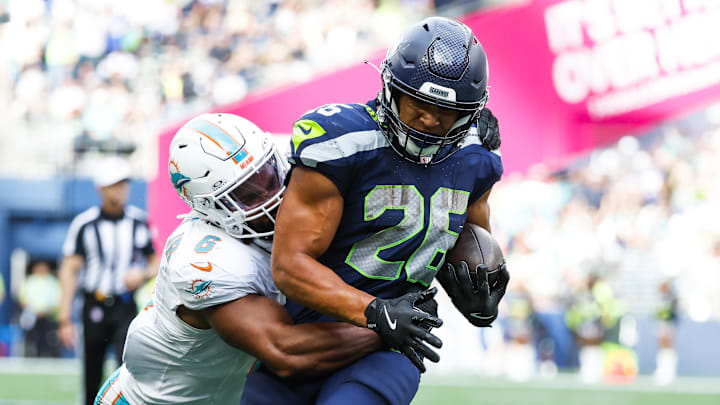 Sep 22, 2024; Seattle, Washington, USA; Seattle Seahawks running back Zach Charbonnet (26) rushes for a touchdown against Miami Dolphins linebacker Anthony Walker Jr. (6) during the fourth quarter at Lumen Field. Sep 22, 2024; Seattle, Washington, USA; Seattle Seahawks running back Zach Charbonnet (26) rushes for a touchdown against Miami Dolphins linebacker Anthony Walker Jr. (6) during the fourth quarter at Lumen Field.