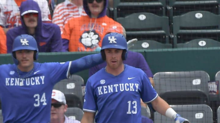 University of Kentucky senior Cole Hage (12) scores under the tag of Clemson freshman Talan Bell (96) as University of Kentucky junior James McCoy (13) and Carson Hansen (34) signal safe behind the play, during the bottom of the third inning at the NCAA baseball Clemson Regional at Doug Kingsmore Stadium in Clemson, S.C. Sunday, June 1, 2025.