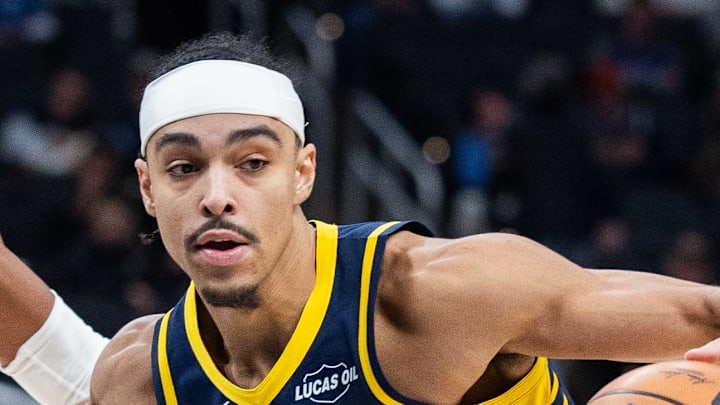 Indiana Pacers guard Andrew Nembhard dribbles the ball while Denver Nuggets guard Peyton Watson defends Indiana Pacers guard Andrew Nembhard dribbles the ball while Denver Nuggets guard Peyton Watson defends