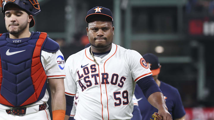 Houston Astros starting pitcher Framber Valdez (59) walks on the field with catcher Yainer Diaz (21) before the game against the Seattle Mariners at Daikin Park. 