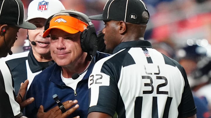 Denver Broncos head coach Sean Payton listens to side judge Boris Cheek and field judge Nate Jones against the Los Angeles Rams Denver Broncos head coach Sean Payton listens to side judge Boris Cheek and field judge Nate Jones against the Los Angeles Rams
