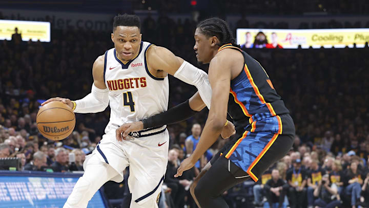 May 5, 2025; Oklahoma City, Oklahoma, USA; Denver Nuggets guard Russell Westbrook (4) drives against Oklahoma City Thunder forward Jalen Williams (8) during the second quarter during game one of the second round for the 2025 NBA Playoffs at Paycom Center. Mandatory Credit: Alonzo Adams-Imagn Images