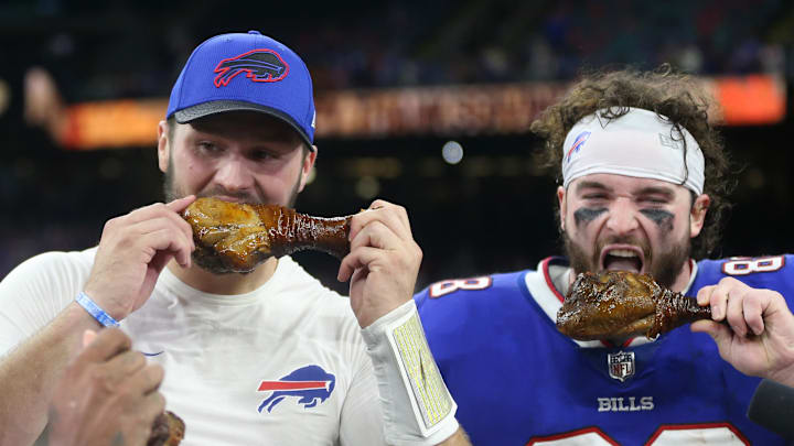Nov 25, 2021; New Orleans, Louisiana, USA; Buffalo Bills wide receiver Stefon Diggs (14) and quarterback Josh Allen (17) and tight end Dawson Knox (88) enjoy a turkey leg at the end of their game against the New Orleans Saints at the Caesars Superdome. Mandatory Credit: Chuck Cook-Imagn Images