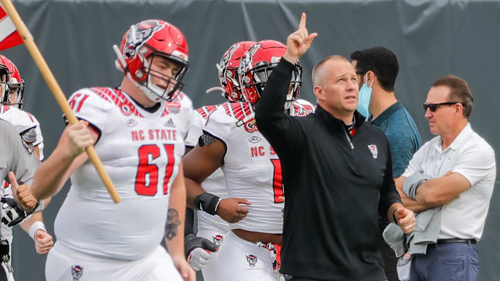 Jan 2, 2021; Jacksonville, FL, USA; North Carolina State Wolfpack head coach Dave Doeren leads his team onto the field before the game against the Kentucky Wildcats at TIAA Bank Field. Mandatory Credit: Mike Watters-Imagn Images Jan 2, 2021; Jacksonville, FL, USA; North Carolina State Wolfpack head coach Dave Doeren leads his team onto the field before the game against the Kentucky Wildcats at TIAA Bank Field. Mandatory Credit: Mike Watters-Imagn Images