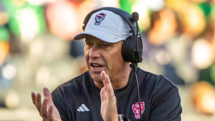 Oct 11, 2025; South Bend, Indiana, USA; NC State Wolfpack head coach Dave Doeren claps as he walks onto the field against the Notre Dame Fighting Irish during the second half at Notre Dame Stadium. Mandatory Credit: Michael Caterina-Imagn Images