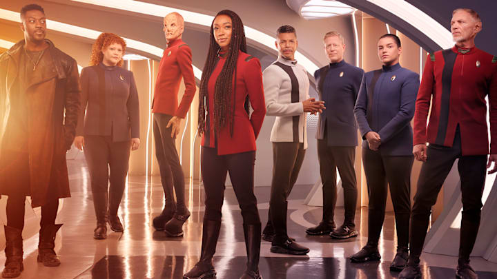L-R David Ajala as Book, Mary Wiseman as Tilly, Doug Jones as Saru, Sonequa Martin-Green as Burnham, Wilson Cruz as Culber, Blu Del Barrio as Adira and Callum Keith Rennie as Raynor in season 5 of the Paramount+ original series STAR TREK: DISCOVERY. Photo Credit: James Dimmock/Paramount+ L-R David Ajala as Book, Mary Wiseman as Tilly, Doug Jones as Saru, Sonequa Martin-Green as Burnham, Wilson Cruz as Culber, Blu Del Barrio as Adira and Callum Keith Rennie as Raynor in season 5 of the Paramount+ original series STAR TREK: DISCOVERY. Photo Credit: James Dimmock/Paramount+