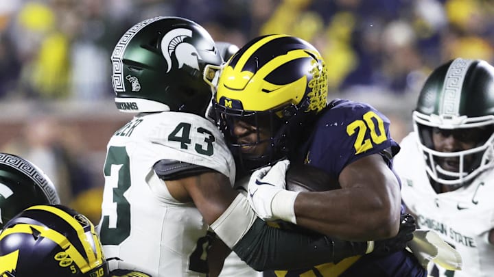 Oct 26, 2024; Ann Arbor, Michigan, USA; Michigan Wolverines running back Kalel Mullings (20) itb Michigan State Spartans defensive back Malik Spencer (43) in the first half at Michigan Stadium. Oct 26, 2024; Ann Arbor, Michigan, USA; Michigan Wolverines running back Kalel Mullings (20) itb Michigan State Spartans defensive back Malik Spencer (43) in the first half at Michigan Stadium.