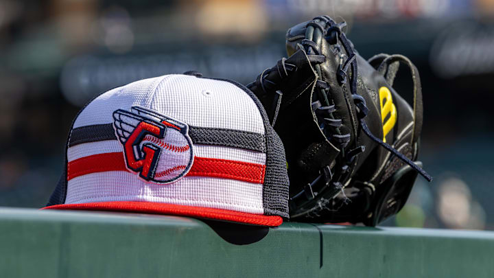 Jul 8, 2024; Detroit, Michigan, USA; A Cleveland Guardians baseball cap and glove sit on the dugout rail before the game against the Detroit Tigers at Comerica Park. Mandatory Credit: David Reginek-Imagn Images Jul 8, 2024; Detroit, Michigan, USA; A Cleveland Guardians baseball cap and glove sit on the dugout rail before the game against the Detroit Tigers at Comerica Park. Mandatory Credit: David Reginek-Imagn Images