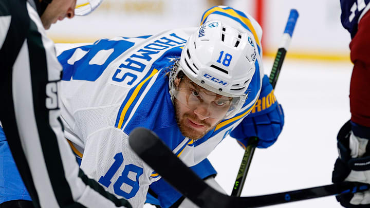 Apr 5, 2026; Denver, Colorado, USA; St. Louis Blues center Robert Thomas (18) faces off against Colorado Avalanche center Brock Nelson (11) as linesman Travis Gawryletz (67) drops the puck in the third period at Ball Arena. Mandatory Credit: Isaiah J. Downing-Imagn Images