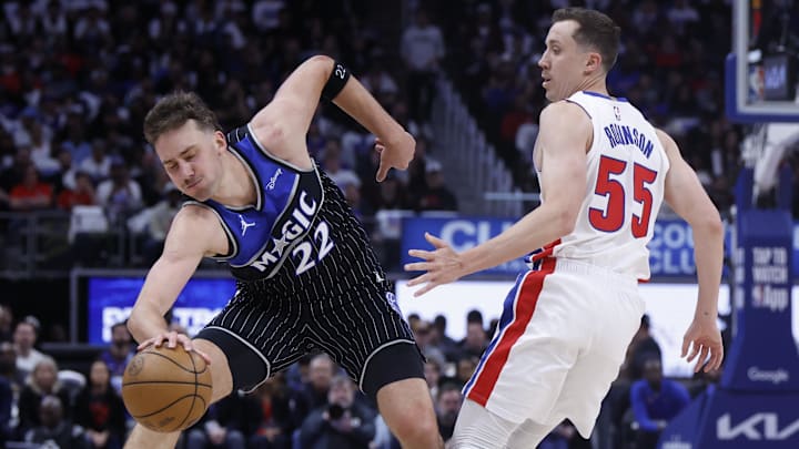 Apr 19, 2026; Detroit, Michigan, USA; Orlando Magic forward Franz Wagner (22) is fouled by Detroit Pistons guard Duncan Robinson (55) in the first half during the 2026 NBA Playoffs at Little Caesars Arena.