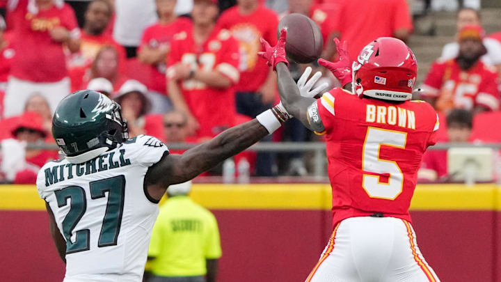 Sep 14, 2025; Kansas City, Missouri, USA; Kansas City Chiefs wide receiver Hollywood Brown (5) makes a catch defended by Philadelphia Eagles cornerback Quinyon Mitchell (27) during the fourth quarter of the game at GEHA Field at Arrowhead Stadium. Mandatory Credit: Denny Medley-Imagn Images
