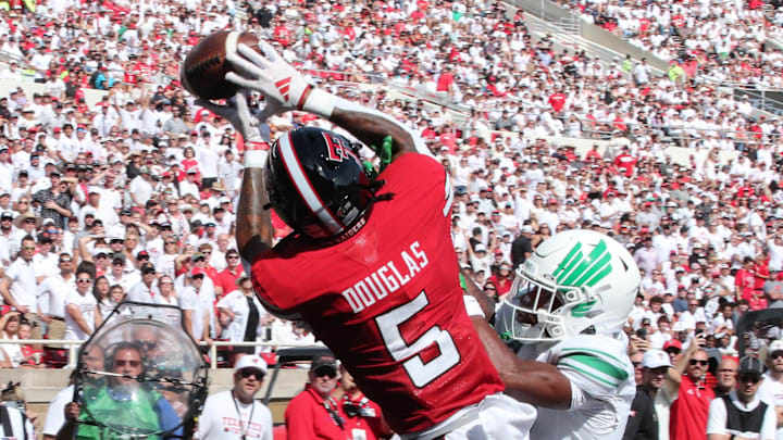 Sep 14, 2024; Lubbock, Texas, USA; Texas Tech Red Raiders wide receiver Caleb Douglas (5) battles for a pass against North Texas Mean Green defensive safety Taylor Starling (17) in the first half at Jones AT&T Stadium and Cody Campbell Field. Mandatory Credit: Michael C. Johnson-Imagn Images Sep 14, 2024; Lubbock, Texas, USA; Texas Tech Red Raiders wide receiver Caleb Douglas (5) battles for a pass against North Texas Mean Green defensive safety Taylor Starling (17) in the first half at Jones AT&T Stadium and Cody Campbell Field. Mandatory Credit: Michael C. Johnson-Imagn Images
