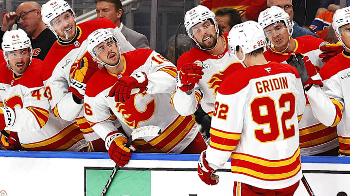 Oct 8, 2025; Edmonton, Alberta, CAN; The Calgary Flames celebrate a first career NHL goal scored by Matvei Gridin (92) during the second period against the Edmonton Oilers at Rogers Place. Mandatory Credit: Perry Nelson-Imagn Images