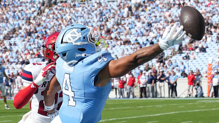 Sep 13, 2025; Chapel Hill, North Carolina, USA; North Carolina Tar Heels running back Caleb Hood (4) isnt able to catch the ball as Richmond Spiders defensive back Devin Geronomi (22) defends in the second quarter at Kenan Stadium. Mandatory Credit: Bob Donnan-Imagn Images Sep 13, 2025; Chapel Hill, North Carolina, USA; North Carolina Tar Heels running back Caleb Hood (4) isnt able to catch the ball as Richmond Spiders defensive back Devin Geronomi (22) defends in the second quarter at Kenan Stadium. Mandatory Credit: Bob Donnan-Imagn Images