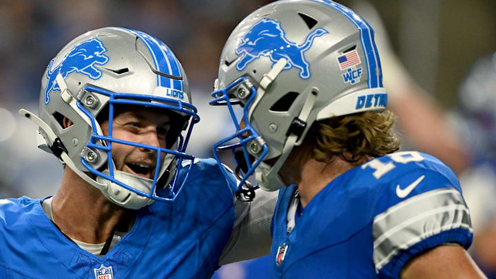 Detroit Lions quarterback Kyle Wilson (8) celebrates with wide receiver Isaac TeSlaa (18) after touchdown grab