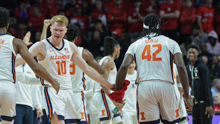 Dec 2, 2023; Piscataway, New Jersey, USA; Illinois Fighting Illini guard Luke Goode (10) celebrates with guard Justin Harmon (4) and forward Dain Dainja (42) during a time out during the first half against the Rutgers Scarlet Knights at Jersey Mike's Arena. Mandatory Credit: Vincent Carchietta-Imagn Images