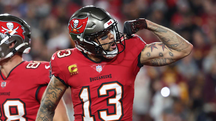Jan 12, 2025; Tampa, Florida, USA; Tampa Bay Buccaneers wide receiver Mike Evans (13) celebrates after a touchdown catch with tight end Cade Otton (88) during the second quarter of a NFC wild card playoff against the Washington Commanders at Raymond James Stadium. Mandatory Credit: Kim Klement Neitzel-Imagn Images