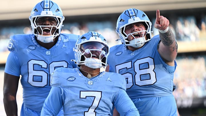 Nov 22, 2025; Chapel Hill, North Carolina, USA; North Carolina Tar Heels quarterback Gio Lopez (7) celebrates after scoring a touchdown during the first half against Duke Blue Devils at Kenan Stadium. Mandatory Credit: William Howard-Imagn Images