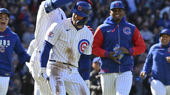 Apr 19, 2026; Chicago, Illinois, USA;  Chicago Cubs second baseman Nico Hoerner (2), center, is surrounded by teammates after he hits an RBI sacrifice fly ball during the tenth inning against the New York Mets at Wrigley Field. Mandatory Credit: Matt Marton-Imagn Images