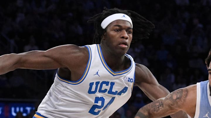 Dec 21, 2024; New York, NY, USA; North Carolina Tar Heels guard RJ Davis (4) drives to the basket while being defended by UCLA Bruins forward William Kyle III (24) during the second half at Madison Square Garden. Mandatory Credit: John Jones-Imagn Images
