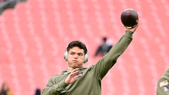 Nov 16, 2025; Cleveland, Ohio, USA; Cleveland Browns quarterback Dillon Gabriel (8) warms up as offensive coordinator Tommy Rees and general manager Andrew Berry look on before a game against the Baltimore Ravens at Huntington Bank Field