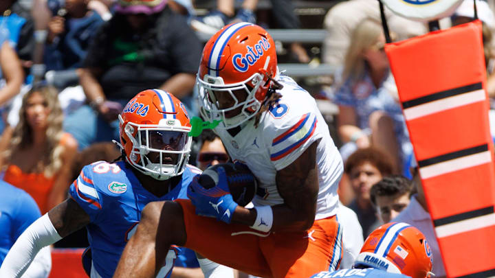 Apr 12, 2025; Gainesville, FL, USA; Florida Gators wide receiver Dallas Wilson (6) makes a catch over Florida Gators defensive back Micheal Caraway Jr. (16) and Florida Gators defensive back Brayden Slade (39) during the first half at Ben Hill Griffin Stadium. Mandatory Credit: Matt Pendleton-Imagn Images Apr 12, 2025; Gainesville, FL, USA; Florida Gators wide receiver Dallas Wilson (6) makes a catch over Florida Gators defensive back Micheal Caraway Jr. (16) and Florida Gators defensive back Brayden Slade (39) during the first half at Ben Hill Griffin Stadium. Mandatory Credit: Matt Pendleton-Imagn Images