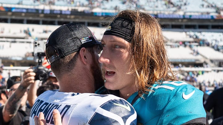Seattle Seahawks quarterback Sam Darnold (14) and Jacksonville Jaguars quarterback Trevor Lawrence (16) greet each other after the game after Seattle defeated the Jaguars 20-12 in an NFL football game at EverBank Stadium, Sunday, Oct. 12, 2025, in Jacksonville, Fla.