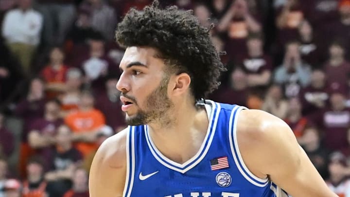 Jan 31, 2026; Blacksburg, Virginia, USA;  Duke Blue Devils forward Cameron Boozer (12) controls the ball as Virginia Tech Hokies forward Tobi Lawal (1) defends during the first half at Cassell Coliseum. Mandatory Credit: Brian Bishop-Imagn Images